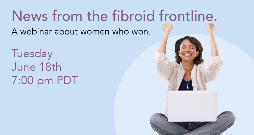 woman sitting with lap top on lap smiling and excited with hands up